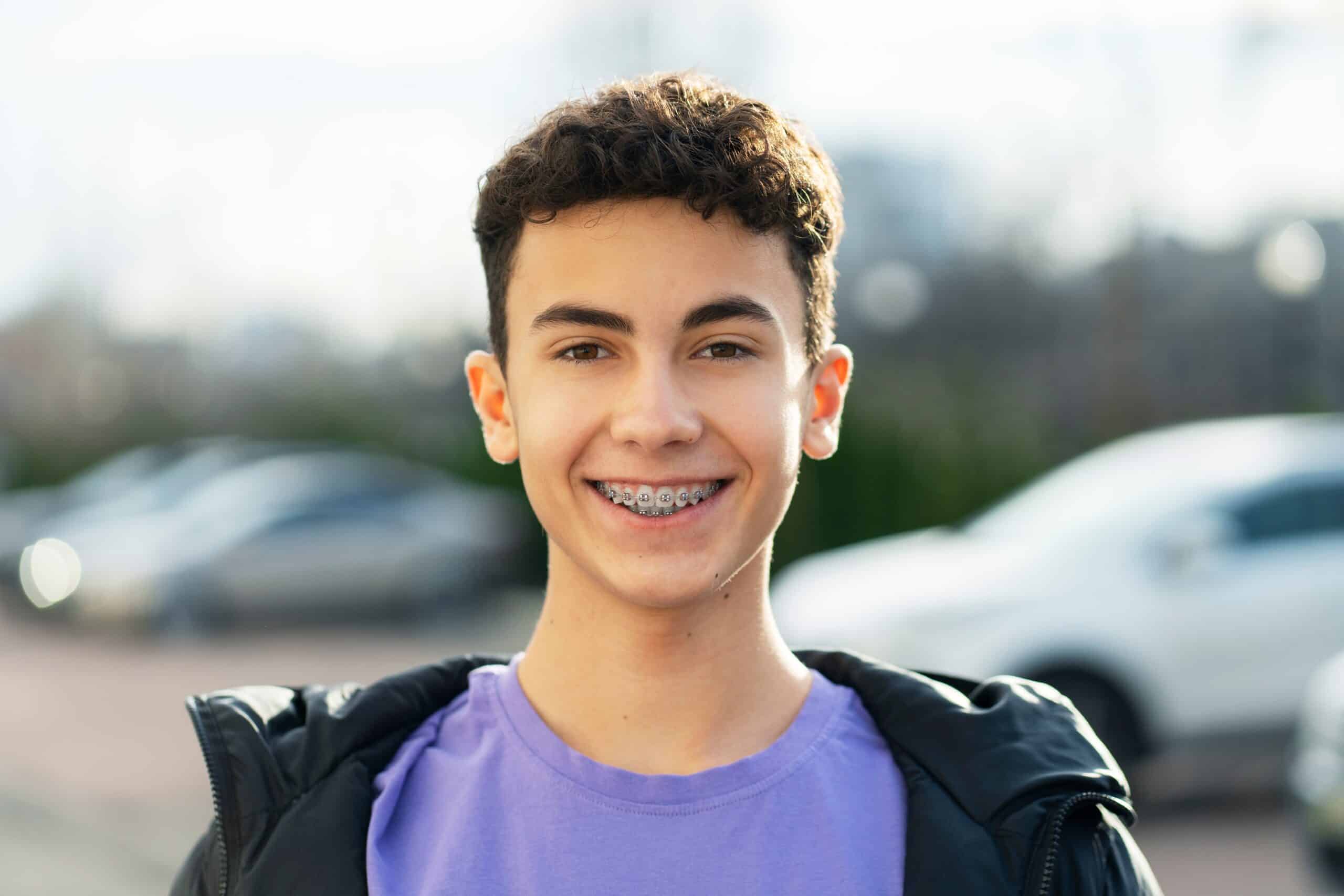 Portrait,Of,Attractive,Smiling,Teenage,Boy,With,Braces,Wearing,Casual